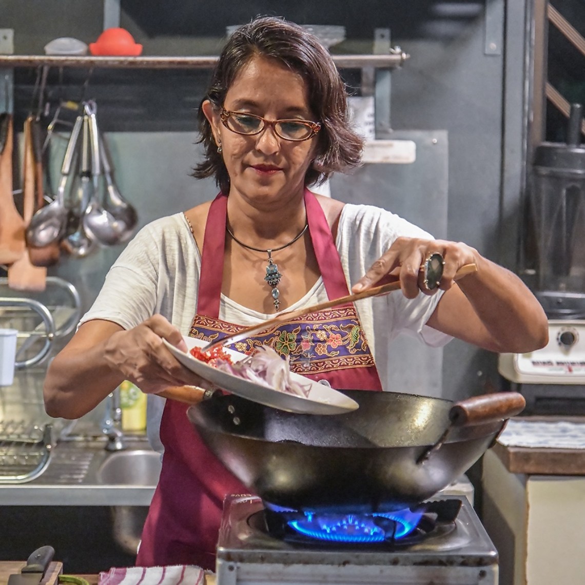 Chef Ruqxana Vasanwala cooking over a wok
